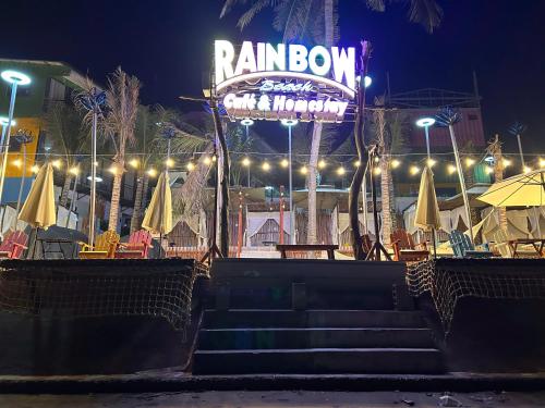a restaurant with chairs and umbrellas at night at Rainbow Beach Mũi Né - Homestay & Coffee in Ấp Khánh Phước (1)