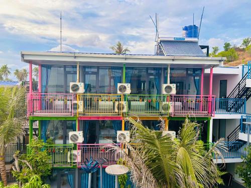 a colorful building with speakers on the side of it at Rainbow Beach Mũi Né - Homestay & Coffee in Ấp Khánh Phước (1)