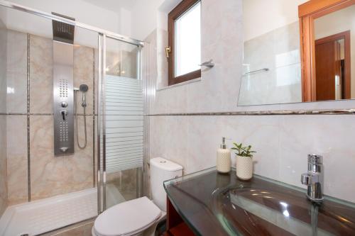 a bathroom with a sink and a toilet and a shower at Villa Althaea in Loutra