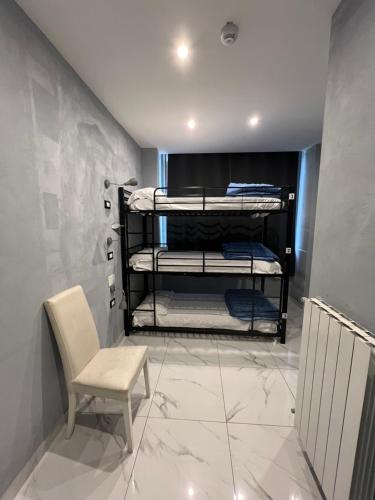 a room with bunk beds and a chair at Lion University & Youth Hostel Milano in Milan