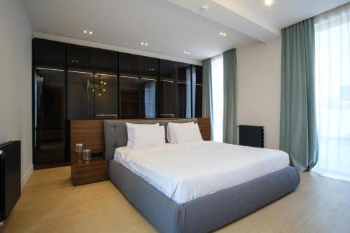 a bedroom with a large bed and a large window at Villa in Avlabari in Tbilisi City