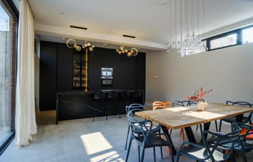 a dining room with a wooden table and chairs at Villa in Avlabari in Tbilisi City