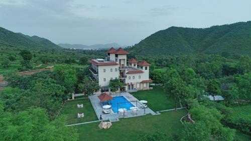 an aerial view of a house with a pool at The Hunting Lodge - Luxury Resort in Udaipur in Udaipur