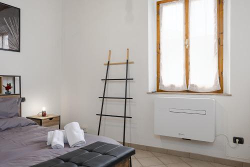 a room with a ladder next to a bed at In Centro a Certaldo in Certaldo