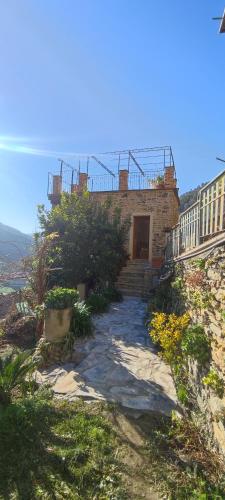 a brick building with a door on a hill at Casa Pablo in Badalucco