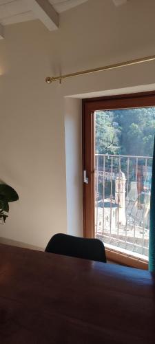 a room with a window with a view of a balcony at Casa Pablo in Badalucco