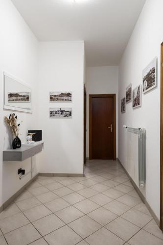 a hallway with white walls and a brown door at In Centro a Certaldo in Certaldo