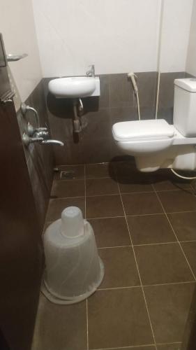 a bathroom with a sink and a toilet at Hotel raajasgrand in Tirupati