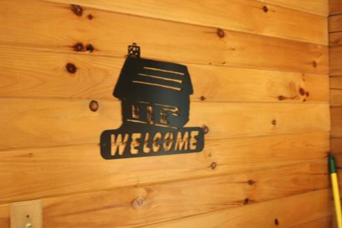 a wall with a sign that says welcome on it at Wren's Nest in Logan