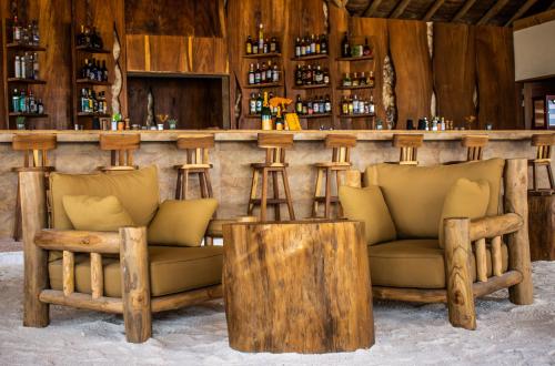 a bar with two couches and a counter at You & Me Maldives - Adults Only - Premium All-Inclusive in Raa Atoll