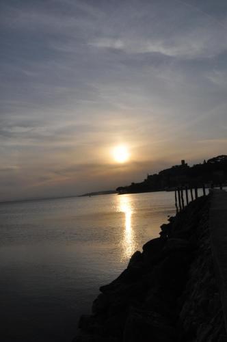 a sunset over a body of water at Hotel Cavalieri in Passignano sul Trasimeno