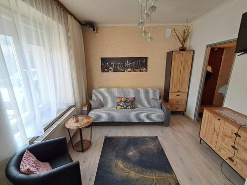 salon z kanapą i stołem w obiekcie Garsoniera Kościuszki w mieście Jasło