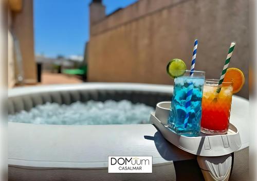 a drink on a tray with two cocktails on a table at DOMuum Holidays -CASALMAR Family Home in Salou