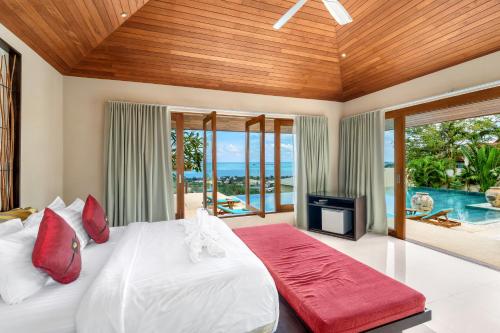 a bedroom with a bed and a view of the ocean at Ban Reemo Luxury Villa in Chaweng