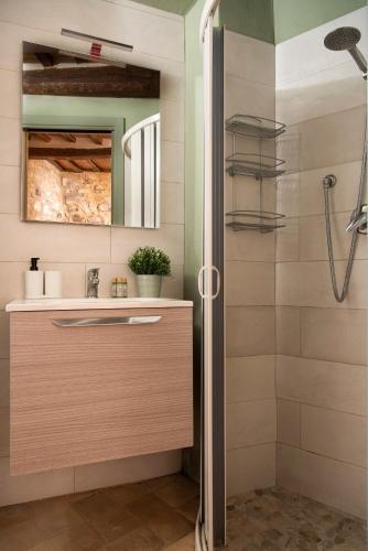 a bathroom with a shower and a sink at Il Borghetto - La Bottega di Adele Loft in Castelnuovo dellʼAbate