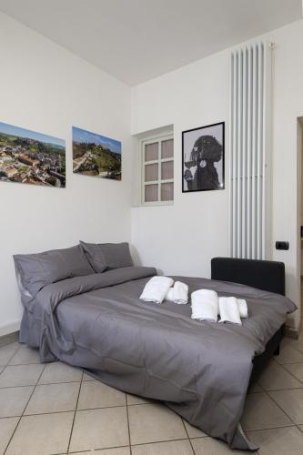 a bedroom with a large bed with three pillows at In Centro a Certaldo in Certaldo