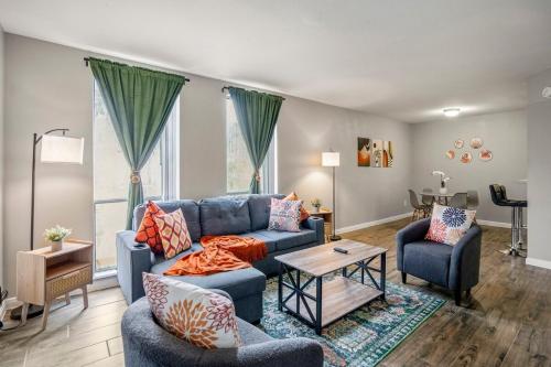 a living room with a blue couch and two chairs at Towne Plaza Apartments 295 - 7 km from FIFA Fest in Houston