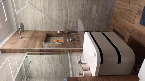 a small bathroom with a bed and a sink at Studio Apartman Casper in Zadar