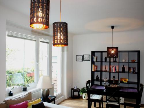 a living room with two pendant lights and a table at Casa Vienna in Vienna