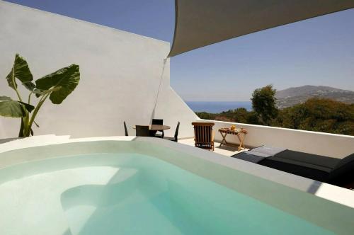 a swimming pool on the roof of a house at Kalisti Hotel & Suites in Fira