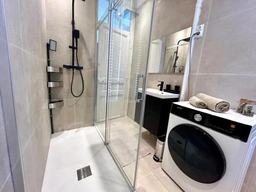 La salle de bains est pourvue d'une douche et d'une télévision. dans l'établissement Appartement moderne à Juans les Pins de 60 m² avec parking, à Juan-les-Pins