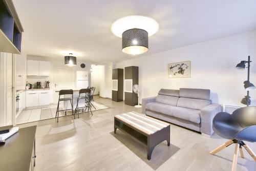 un salon avec un canapé et une cuisine dans l'établissement Modern 2 BR flat near Vieux Port, à Marseille