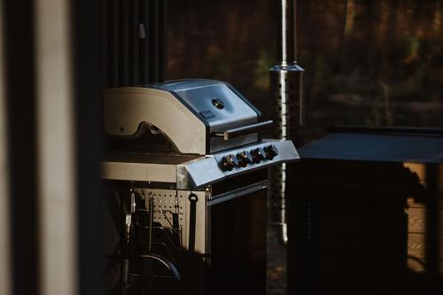 a coffee maker sitting on top of an oven at ForRest Glamp Saulkrasti in Saulkrasti
