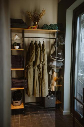 a closet with a bunch of clothes in it at ForRest Glamp Saulkrasti in Saulkrasti