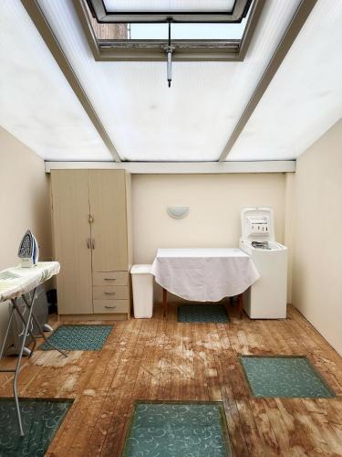 une salle d'hôpital avec une table et un lave-linge dans l'établissement maison de tourisme aux sables d'olonne, à Les Sables-dʼOlonne
