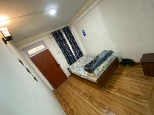 a small room with a couch and a door at Rubysang in Darjeeling