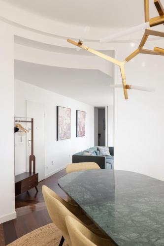 a living room with a table and a couch at Deco Gem in City Center in Lisbon