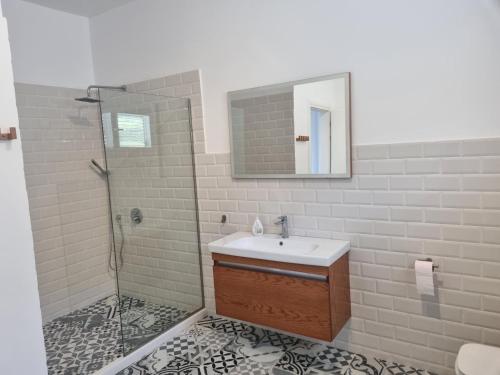 a bathroom with a sink and a shower at Hillside Villa in Mifol