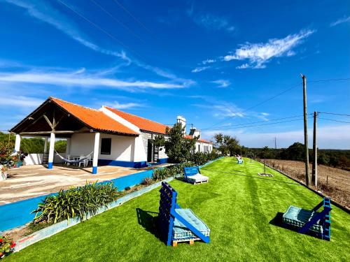 a house with a yard with a swimming pool at A Casinha in São Bartolomeu da Serra