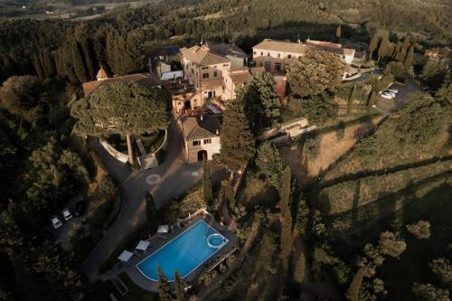 an aerial view of a mansion with a swimming pool at Borgo Bucciano in San Miniato