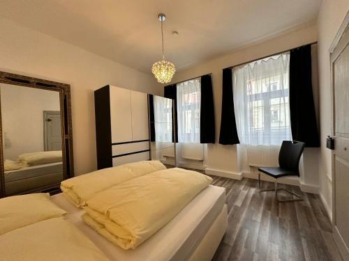 a bedroom with two beds and a mirror at Maxima in Bamberg