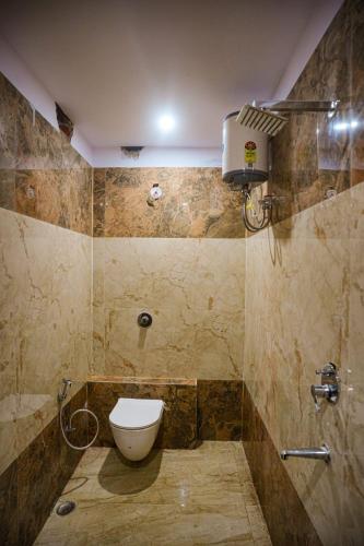 a bathroom with a toilet and a shower at Sapphire By the Ganges in Prayagraj