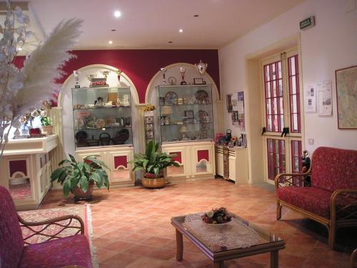 a living room filled with furniture and a table at Hotel Cavalieri in Passignano sul Trasimeno