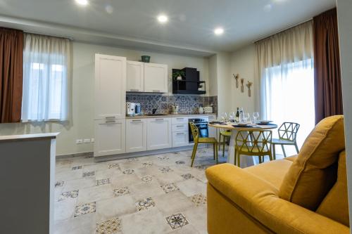a kitchen and living room with a couch and a table at Domus Mea in Forza dʼAgro