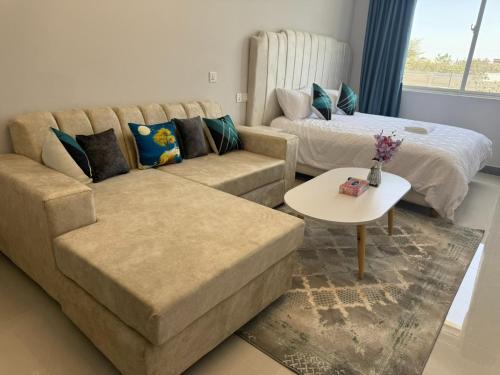 a living room with a couch and a bed at Cozy homes sabaki in Nairobi