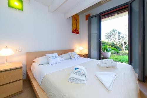 a bedroom with two beds with towels on them at Acquarius Resort Sirmione - MGH in Sirmione