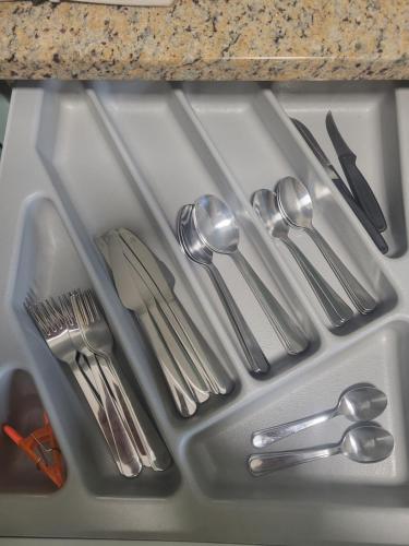 a kitchen sink with silver utensils on it at Casa Laxeira in Tabagón