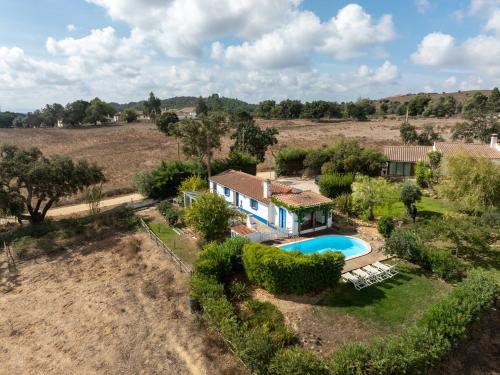 an aerial view of a house with a swimming pool at Monte dos Casarões- Casinha in Odemira
