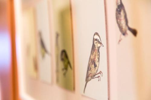 a book with drawings of birds on a wall at UALM Untermarkter Alm in Imst
