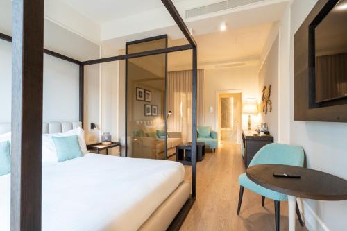a hotel room with a bed and a table and a desk at Anna Teresa Luxury in Pisa
