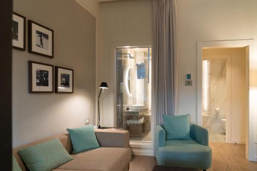 a living room with a couch and two chairs at Anna Teresa Luxury in Pisa