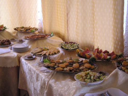 a table with many plates of food on it at Hotel Cavalieri in Passignano sul Trasimeno