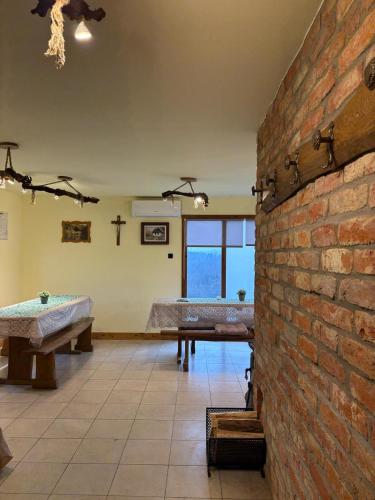 a room with a brick wall and a table at Zagorska Klet in Gorjakovo