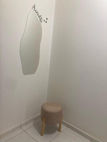 a stool in a room with a sign on the wall at Economize e aproveite a região ou descanse para o voo - 24h in Maceió