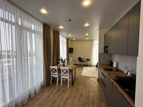a kitchen with a table and a dining room at Smart House Apartments in Lviv