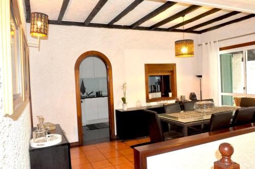 a dining room and living room with a table at Refúgio Guest House in São Vicente